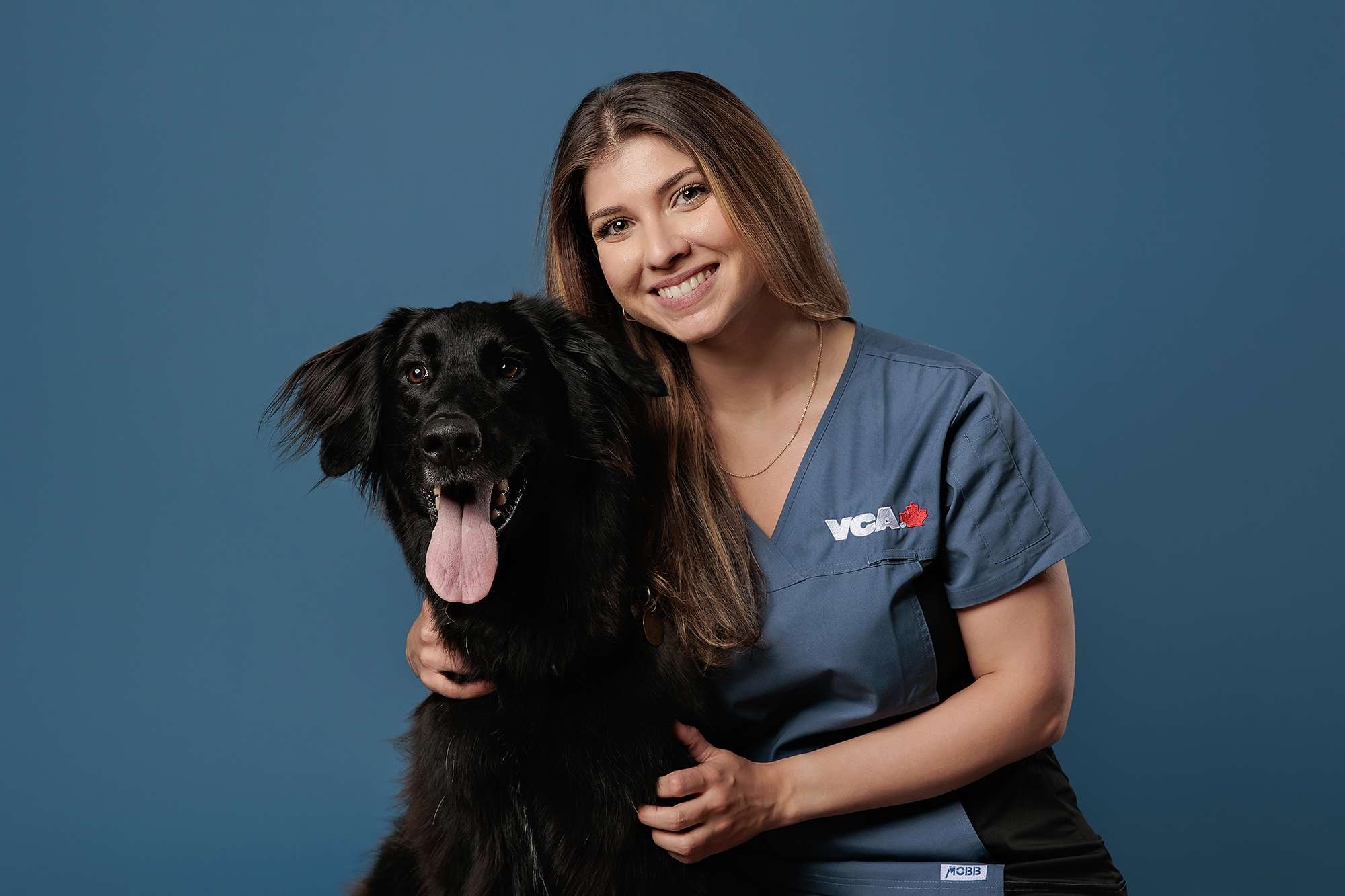 Veterinary hospital headshots in Calgary - posing with a dog