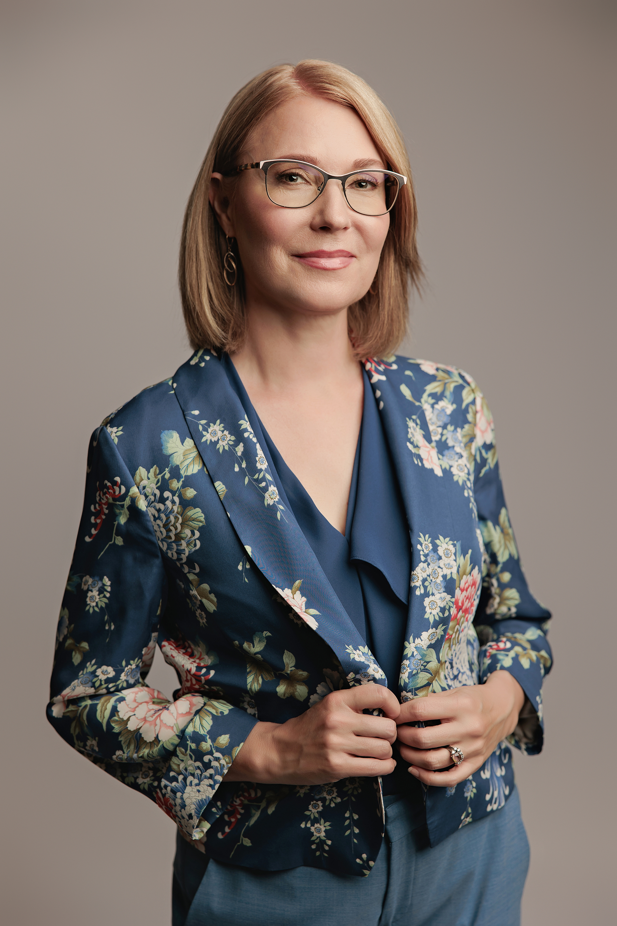 professional headshot of a woman wearing glasses in Calgary